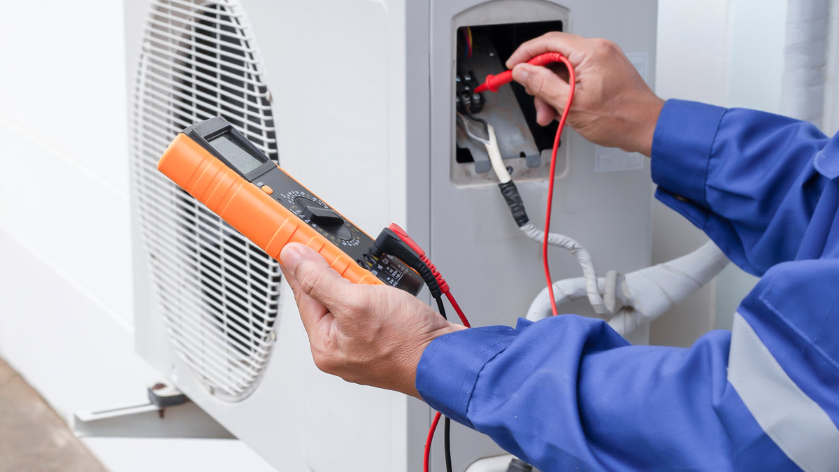 Technician installing an AC unit
